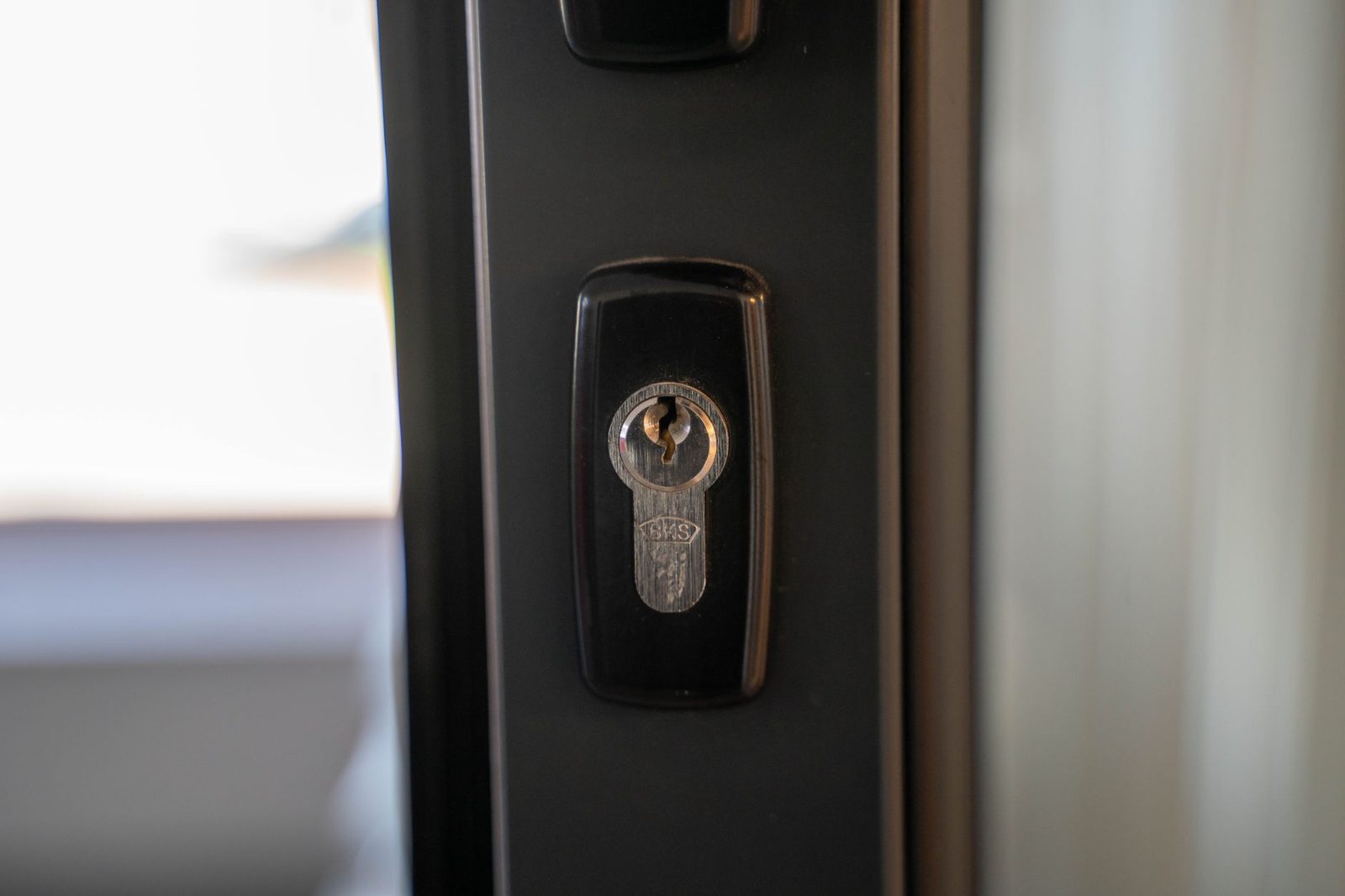 Locksmith technician using non-destructive entry tools on a residential door lock